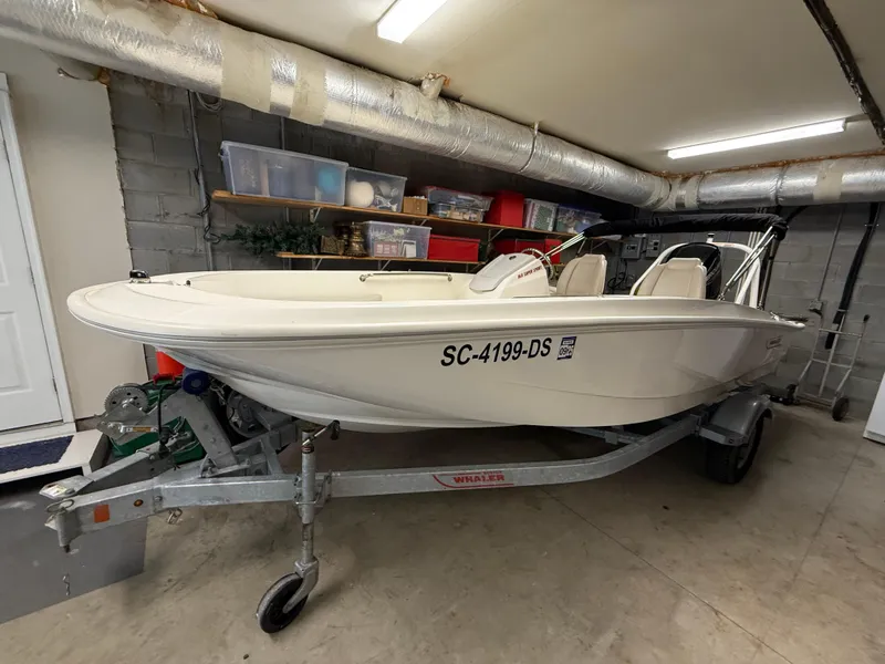 Slide: The Image of 2022 Boston Whaler 160 Super Sport boat on trailer in garage. - 19
