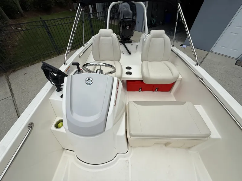 Slide: The Image of 2022 Boston Whaler 160 Super Sport interior with white seating and steering console. - 9