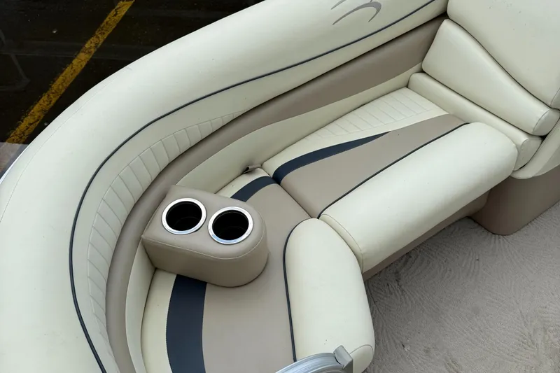 Slide: The Image of 2009 Bennington 1850GL boat interior with beige seating and dual cup holders. - 6