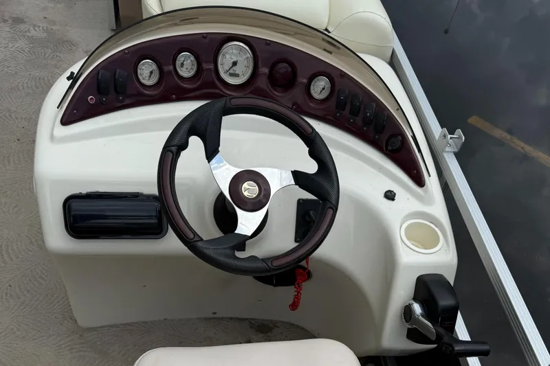 Slide: The Image of Steering console of a 2009 Bennington 1850GL boat with gauges and controls. - 7