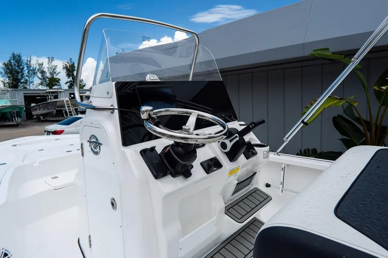 Slide: The Image of 2026 Tidewater 2110 Bay Max boat console with steering wheel and controls. - 14