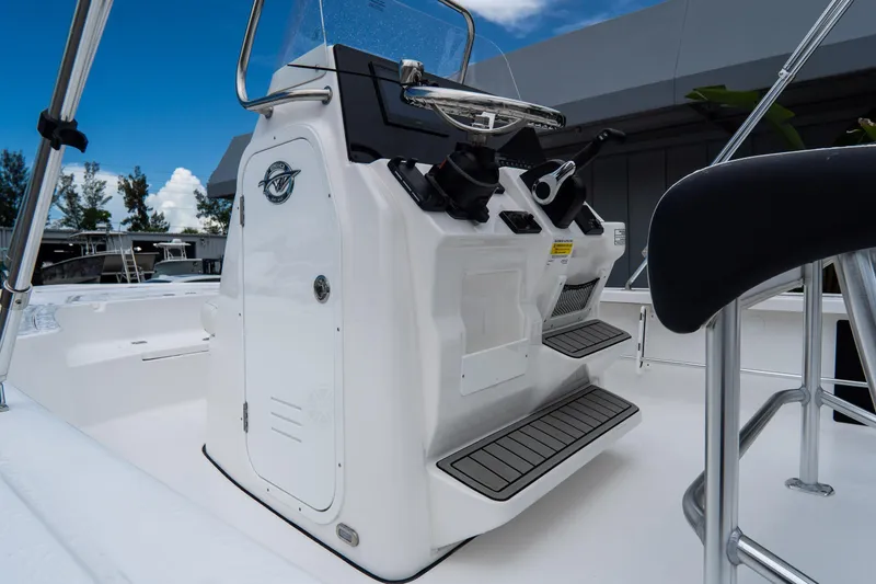 Slide: The Image of 2026 Tidewater 2110 Bay Max boat console with steering wheel and controls. - 15