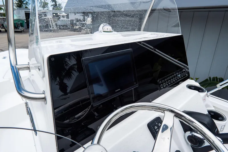 Slide: The Image of 2026 Tidewater 2110 Bay Max boat dashboard with steering wheel and navigation display. - 16