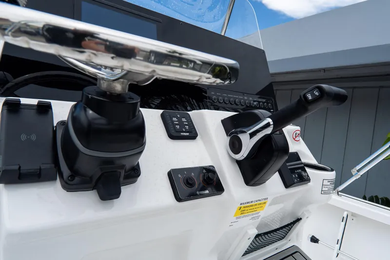 Slide: The Image of 2026 Tidewater 2110 Bay Max boat console with steering wheel and controls. - 17