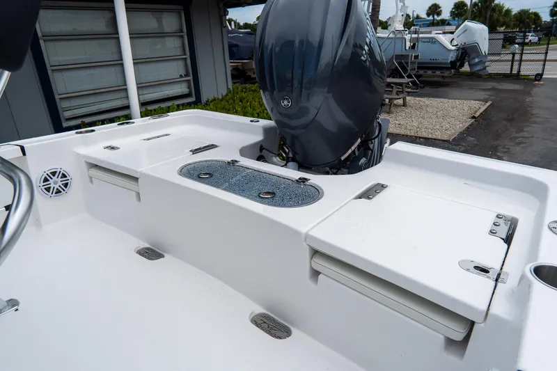 Slide: The Image of 2026 Tidewater 2110 Bay Max boat with outboard motor and storage compartments. - 19