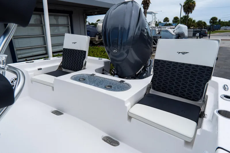 Slide: The Image of 2026 Tidewater 2110 Bay Max boat interior with dual seats and engine view. - 20