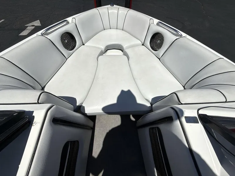 Slide: The Image of 2006 MB Sport 220v boat interior with white seating and built-in speakers. - 11