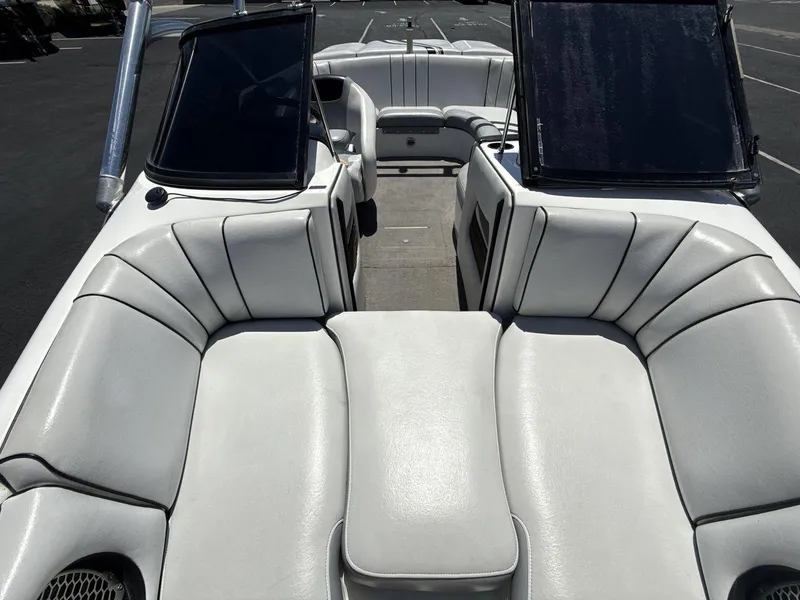 Slide: The Image of 2006 MB Sport 220v boat interior with white leather seating and open windshield. - 12