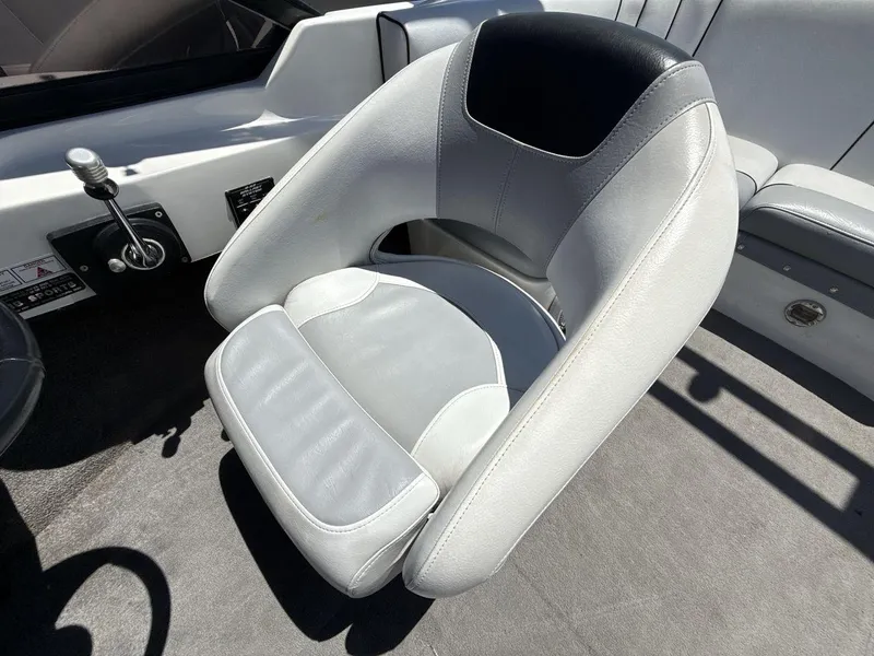 Slide: The Image of 2006 MB Sport 220v boat interior with gray and white seating. - 13