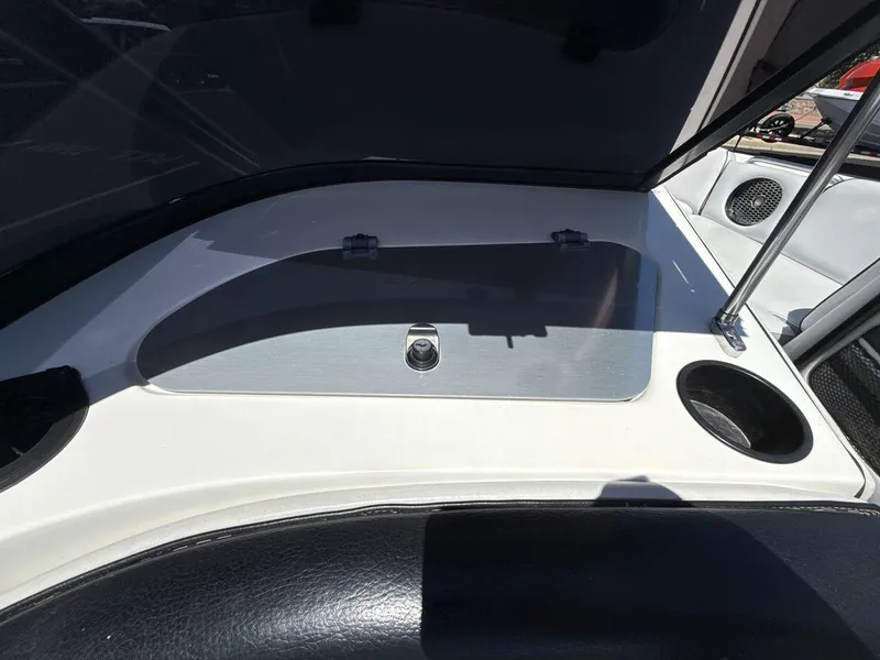 Slide: The Image of 2006 MB Sport 220v boat interior with storage compartment and cup holder. - 18