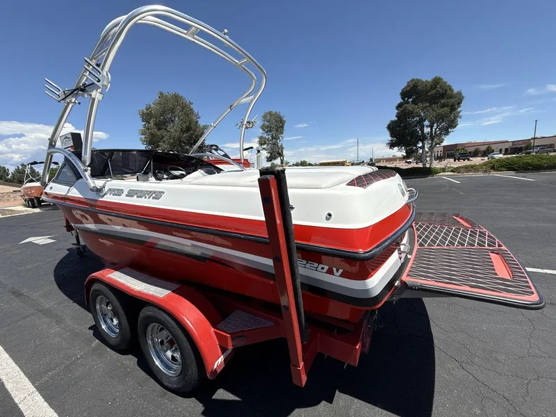 Slide: The Image of 2006 MB Sport 220v boat on trailer, red and white design, parked outdoors. - 3