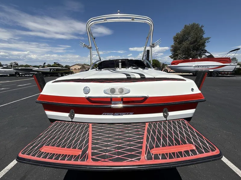 Slide: The Image of 2006 MB Sport 220v boat with red and white design, parked outdoors. - 4