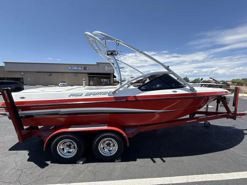 Slide: The Image of Red 2006 MB Sport 220v boat on trailer in parking lot, clear sky background. - 6