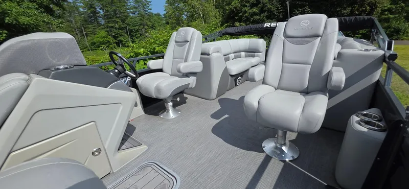 Slide: The Image of 2022 Regency 230 LE3 boat interior with plush seating and modern design. - 12