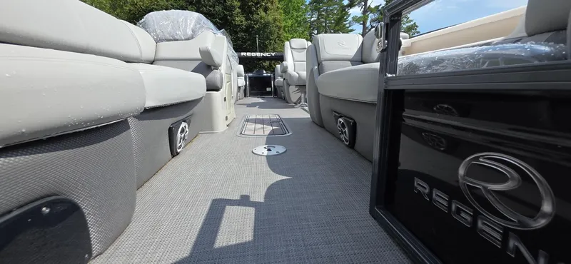 Slide: The Image of 2022 Regency 230 LE3 pontoon boat interior with plush seating and modern design. - 13