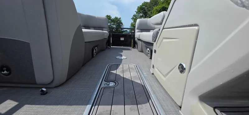 Slide: The Image of 2022 Regency 230 LE3 pontoon boat interior with gray seating and flooring. - 15