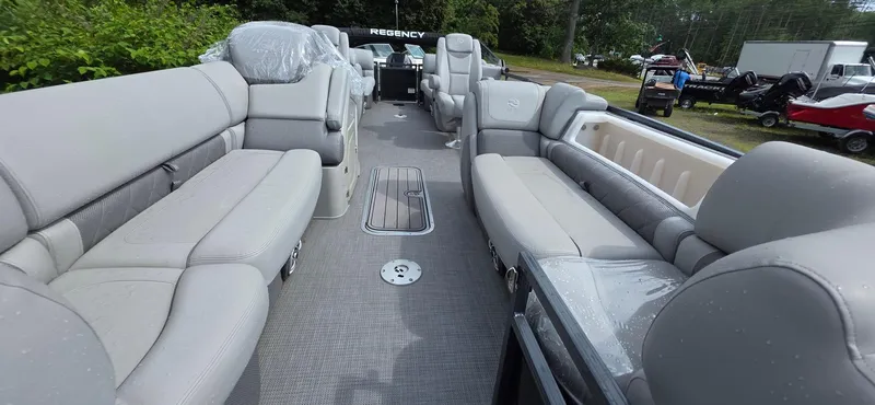 Slide: The Image of 2022 Regency 230 LE3 pontoon boat interior with plush seating and modern design. - 4