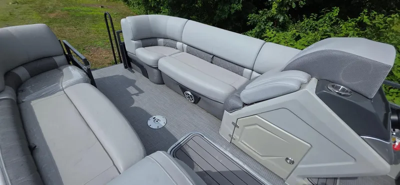 Slide: The Image of 2022 Regency 230 LE3 pontoon boat interior with plush seating and modern design. - 7