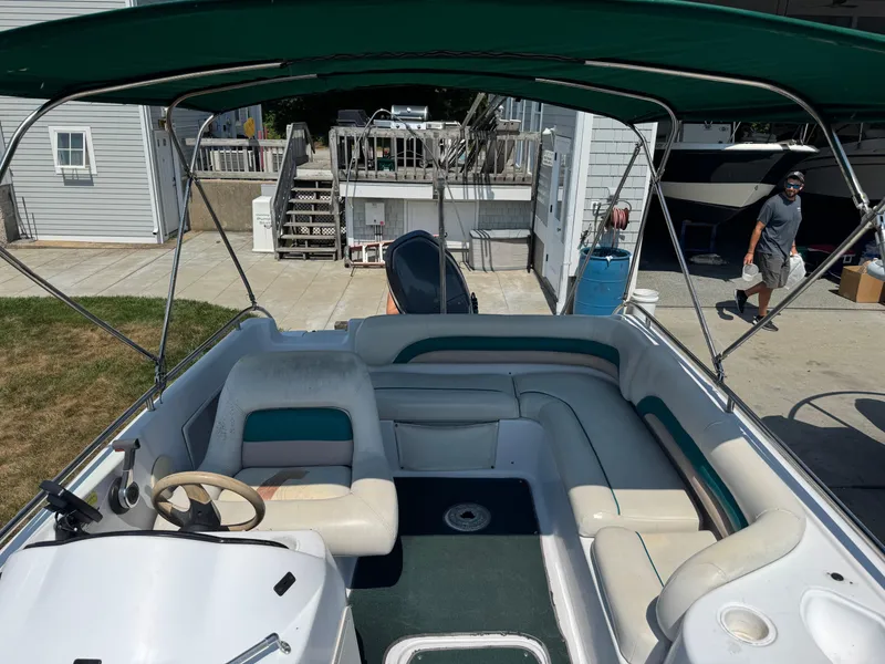 Slide: The Image of 2001 Hurricane FunDeck GS 201 OB boat with green canopy and spacious seating. - 10