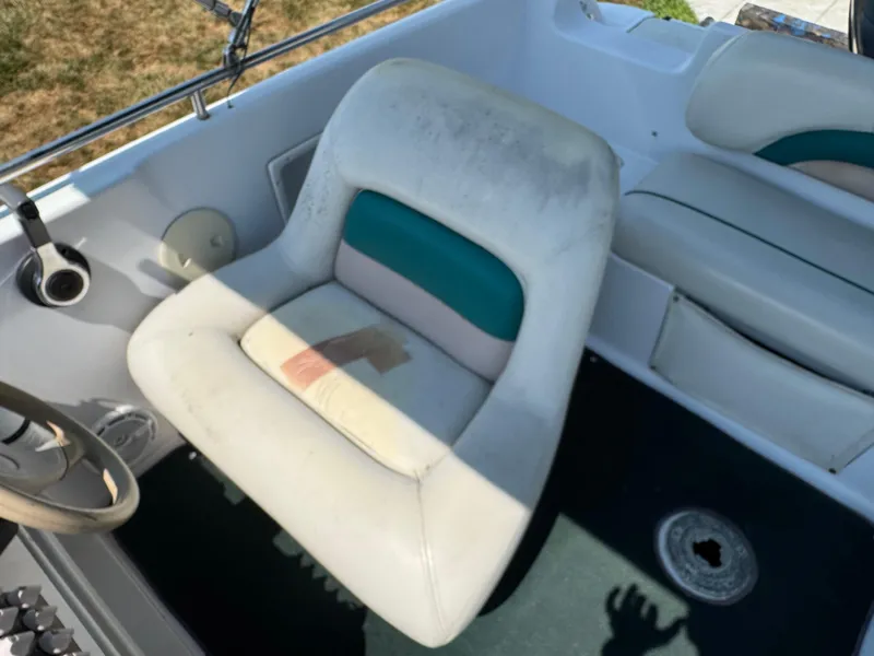 Slide: The Image of 2001 Hurricane FunDeck GS 201 OB boat interior with worn seating and steering wheel. - 19