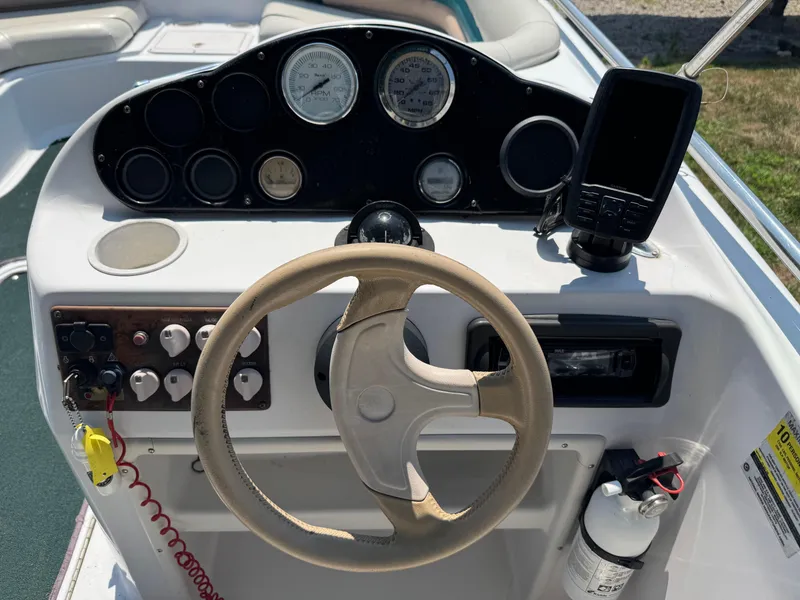 Slide: The Image of 2001 Hurricane FunDeck GS 201 OB boat dashboard with steering wheel and gauges. - 21