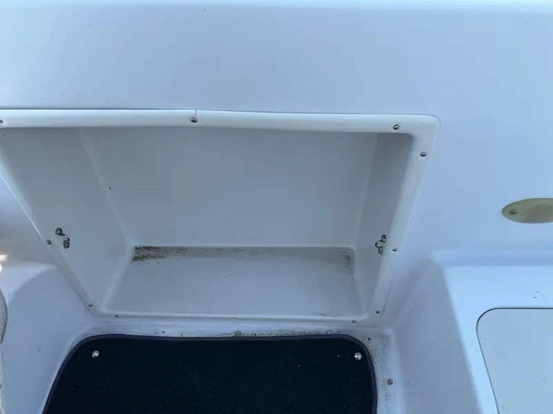 Slide: The Image of 2001 Hurricane FunDeck GS 201 OB storage compartment with open hatch, showing interior details. - 23