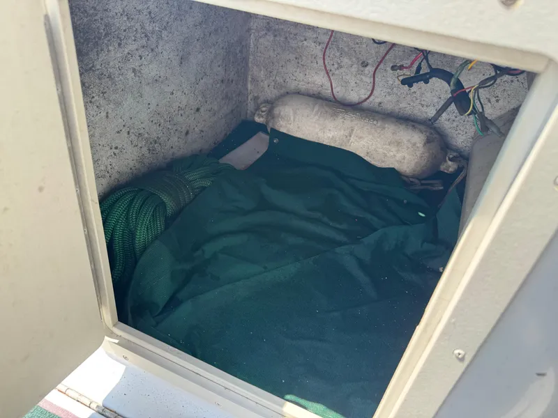 Slide: The Image of Storage compartment of a 2001 Hurricane FunDeck GS 201 OB boat with rope and fender. - 24
