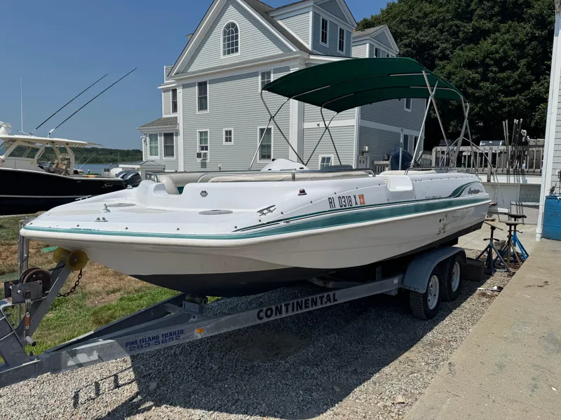 Slide: The Image of 2001 Hurricane FunDeck GS 201 OB boat on trailer, parked near a house. - 3
