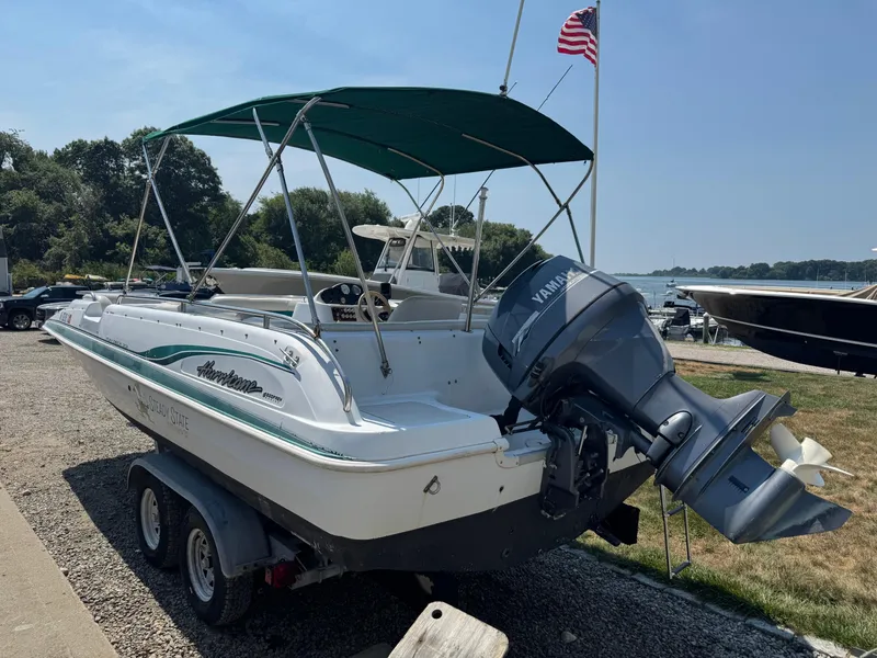 Slide: The Image of 2001 Hurricane FunDeck GS 201 OB boat with Yamaha outboard motor, parked on a trailer. - 5
