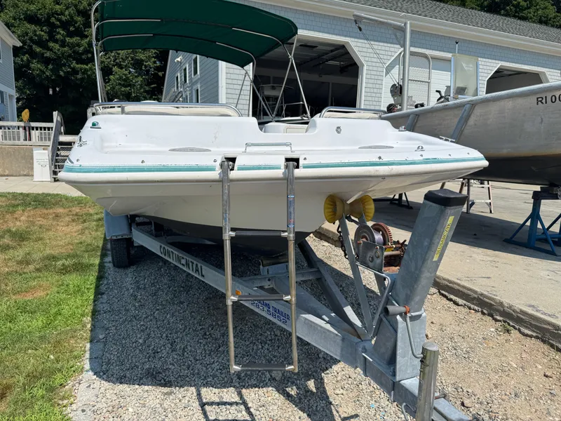 Slide: The Image of 2001 Hurricane FunDeck GS 201 OB boat on trailer, parked near garage. - 9