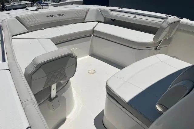 Slide: The Image of 2026 World Cat 325 CC boat interior with white cushioned seating. - 2