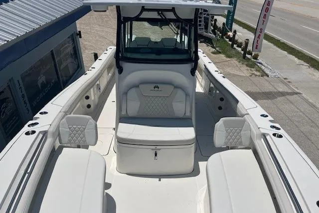 Slide: The Image of 2026 World Cat 325 CC boat interior with white seating and modern design. - 4