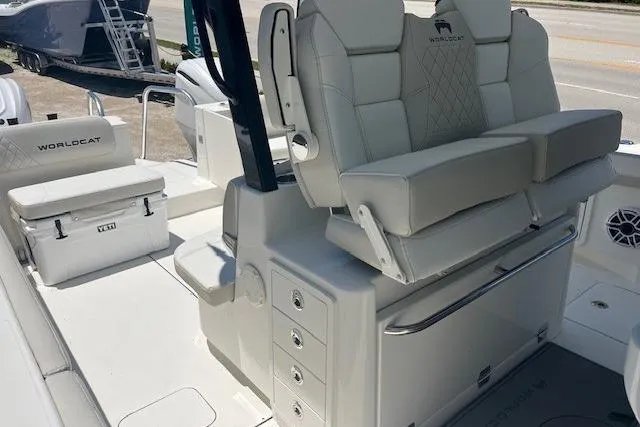 Slide: The Image of 2026 World Cat 325 CC boat interior with cushioned seating and storage compartments. - 5