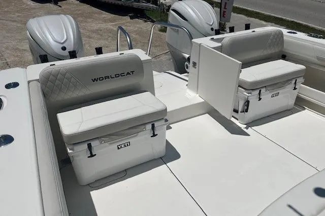 Slide: The Image of 2026 World Cat 325 CC boat interior with Yeti coolers and dual seating. - 6