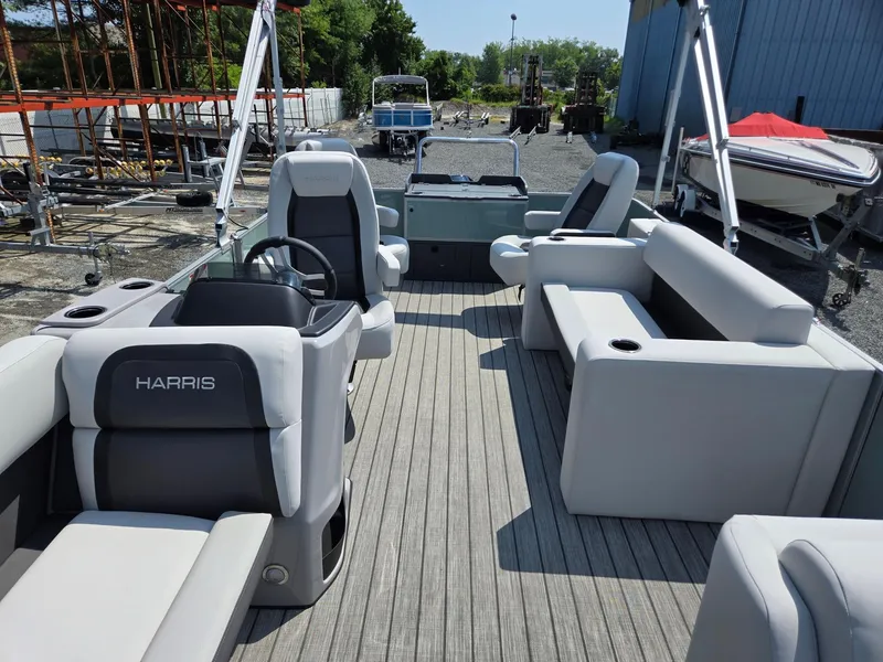 Slide: The Image of 2026 Harris Cruiser 210 pontoon boat interior with plush seating and steering console. - 10