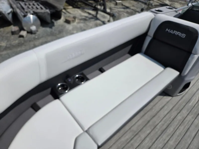 Slide: The Image of 2026 Harris Cruiser 210 boat interior with cushioned seating and cup holders. - 11