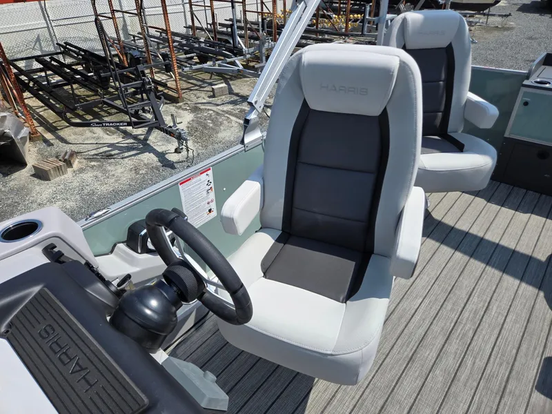 Slide: The Image of 2026 Harris Cruiser 210 boat interior with comfortable seating and steering wheel. - 15