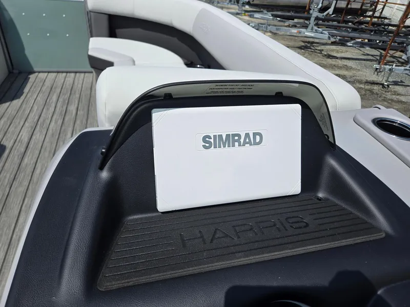 Slide: The Image of 2026 Harris Cruiser 210 boat dashboard with Simrad navigation system. - 17
