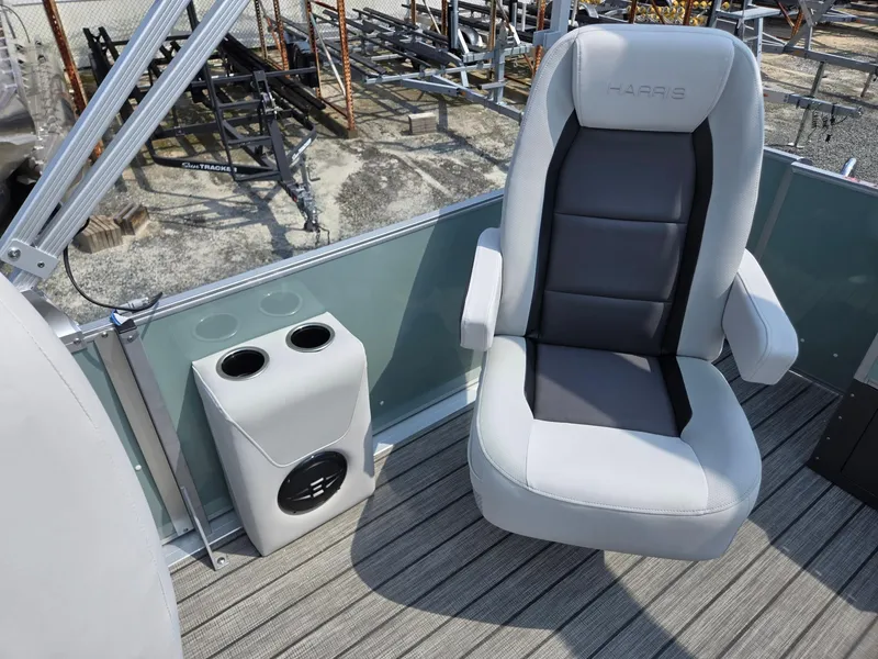 Slide: The Image of 2026 Harris Cruiser 210 boat seat with cup holders on deck. - 21