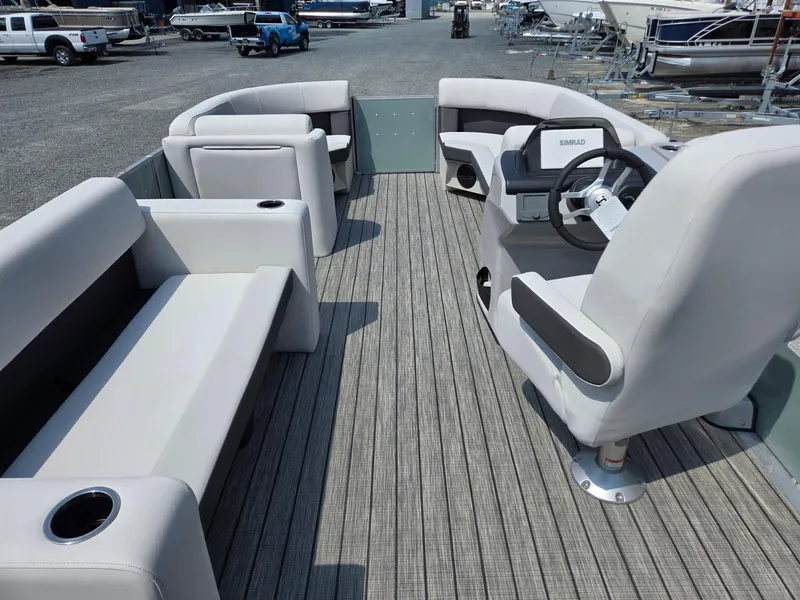 Slide: The Image of 2026 Harris Cruiser 210 pontoon boat interior with plush seating and modern steering console. - 30