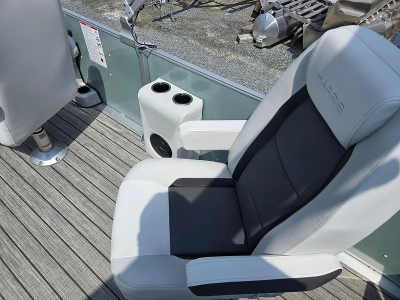 Slide: The Image of Captain's chair on 2026 Harris Cruiser 210 boat with cup holders and speaker. - 31