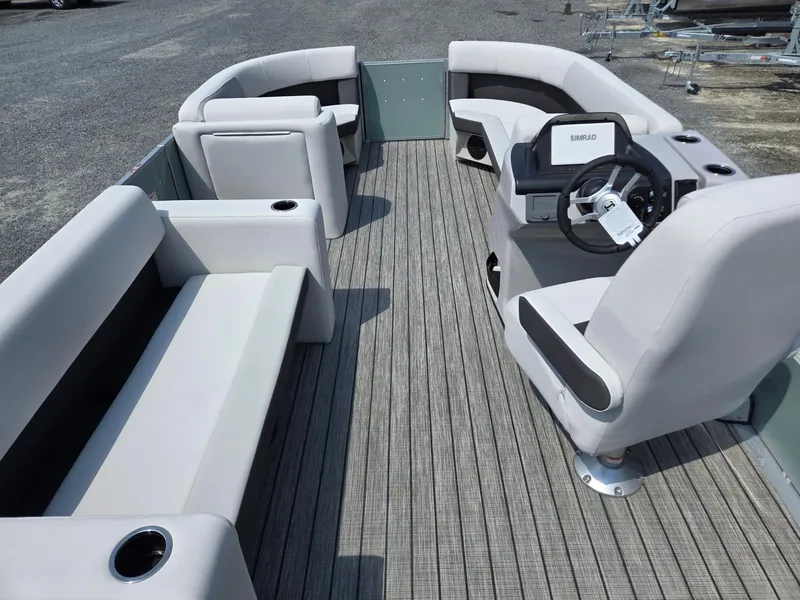 Slide: The Image of 2026 Harris Cruiser 210 pontoon boat interior with plush seating and modern steering console. - 32