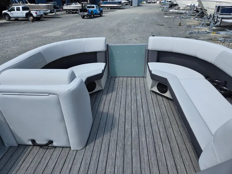 Slide: The Image of 2026 Harris Cruiser 210 boat interior with gray seating and wood-style flooring. - 34