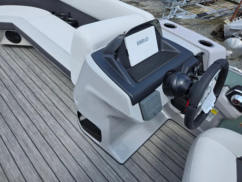 Slide: The Image of 2026 Harris Cruiser 210 boat interior with steering console and seating. - 36