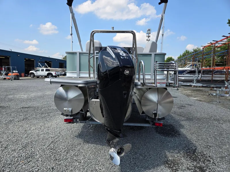 Slide: The Image of 2026 Harris Cruiser 210 pontoon boat with powerful outboard motor, parked on gravel lot. - 4