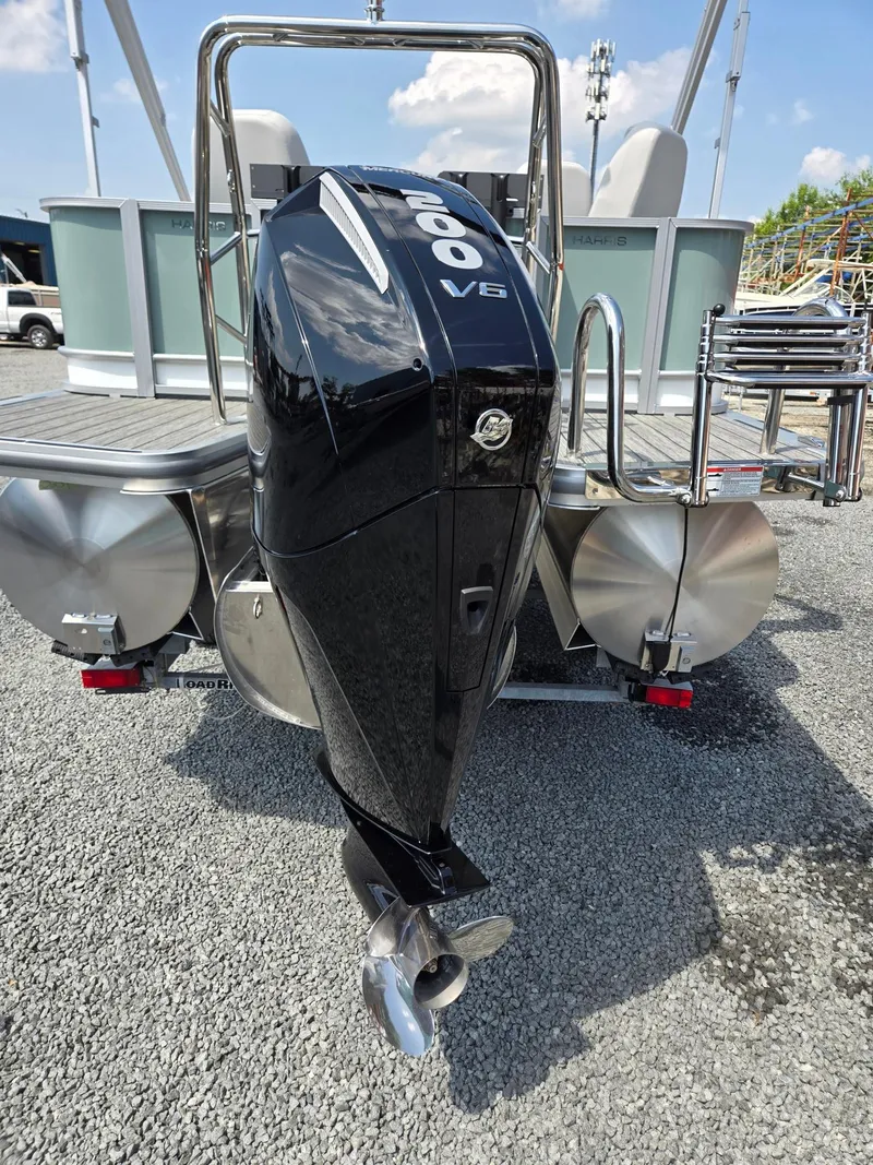 Slide: The Image of 2026 Harris Cruiser 210 pontoon boat with a powerful 200 V6 engine, parked on gravel. - 43