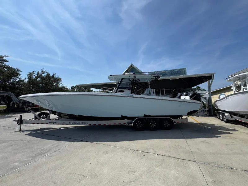 Slide: The Image of 2022 Fountain 38TE boat on trailer under clear blue sky. - 1