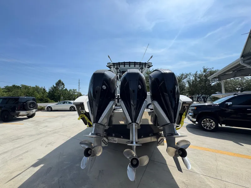 Slide: The Image of 2022 Fountain 38TE boat with four powerful outboard engines in a parking lot. - 14