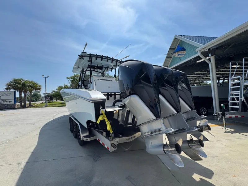 Slide: The Image of 2022 Fountain 38TE boat with triple outboard engines at a marina. - 15