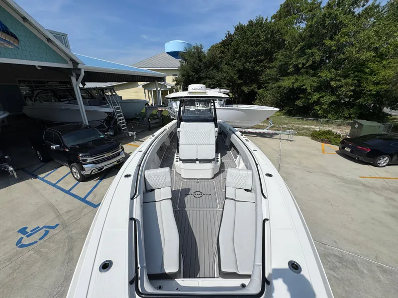 Slide: The Image of 2022 Fountain 38TE boat docked, showcasing sleek design and spacious deck layout. - 22